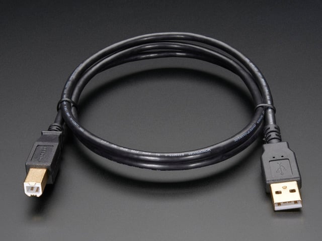 Angled shot of coiled USB-A to USB-B cable.