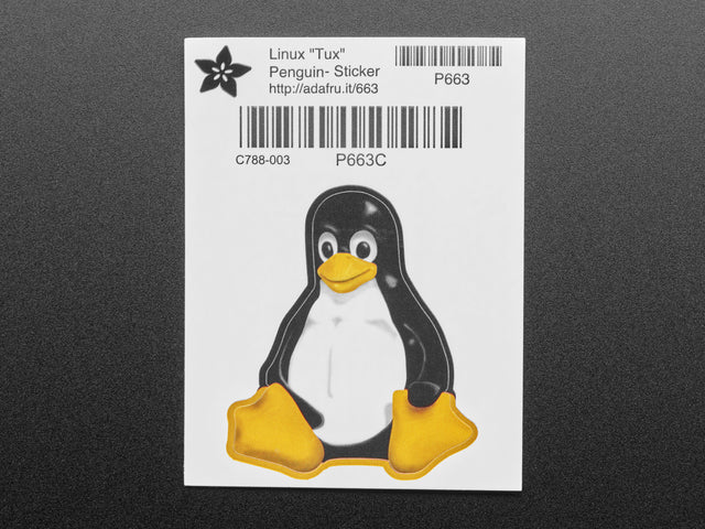 Sticker in the shape of the sitting penguin Linux logo. In black and white, with yellow beak and feet. Mounted on white paper with barcode. 