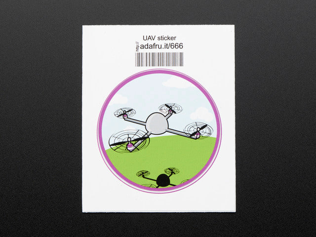 Circular sticker showing a small grey drone over a stylized blue sky, with white clouds, and green grass. Badge is trimmed in purple. Mounted on white paper with barcode.  