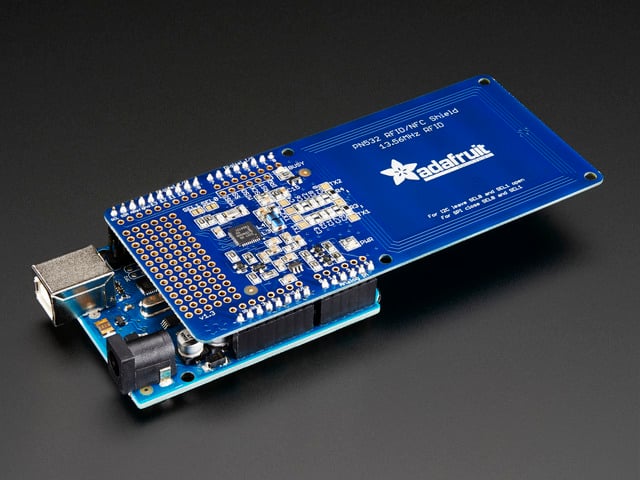 Angled shot of NFC Shield connected to an Arduino.