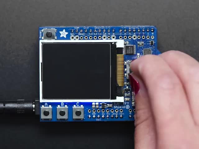 Hand pressing buttons and moving joystick on TFT shield, display shows actions and then displays robot